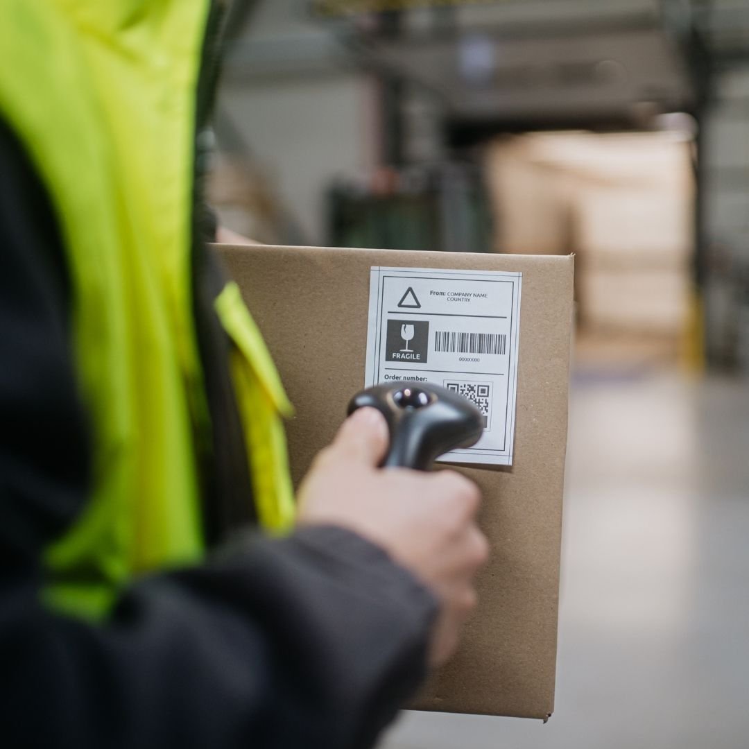 Warehouse worker scanning inventory with barcodes scanner
