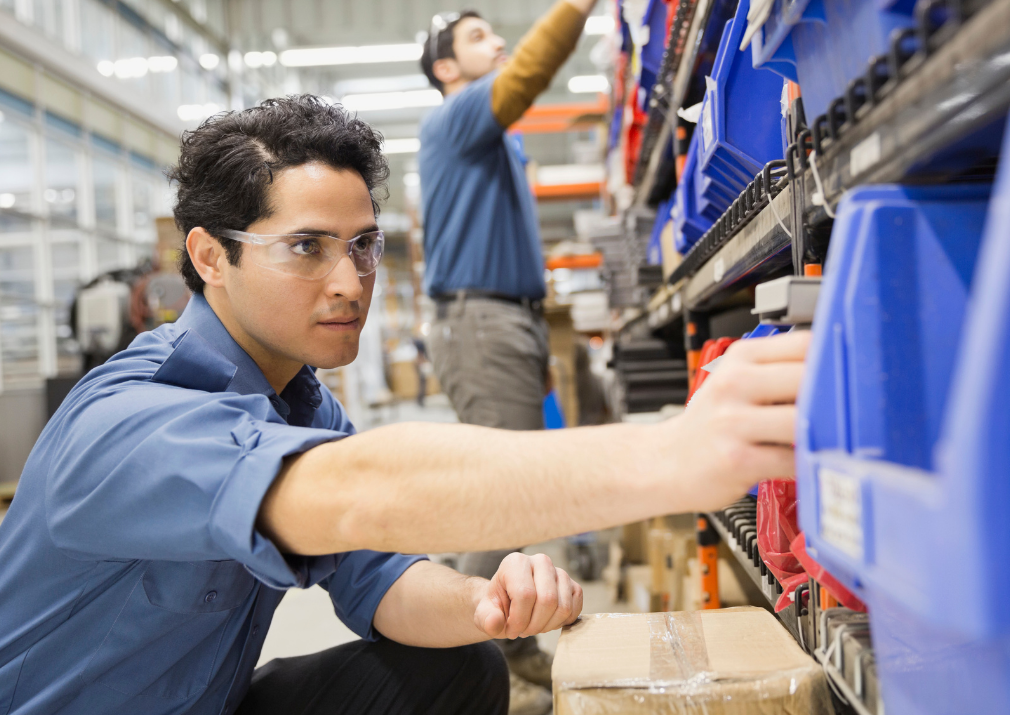 Warehouse worker is doing Pick-to-Light items in shelves