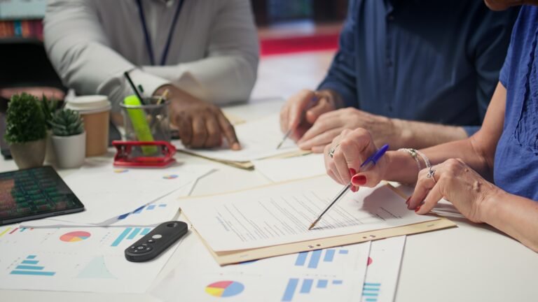 Mature person signing a contract with insurance agency banker